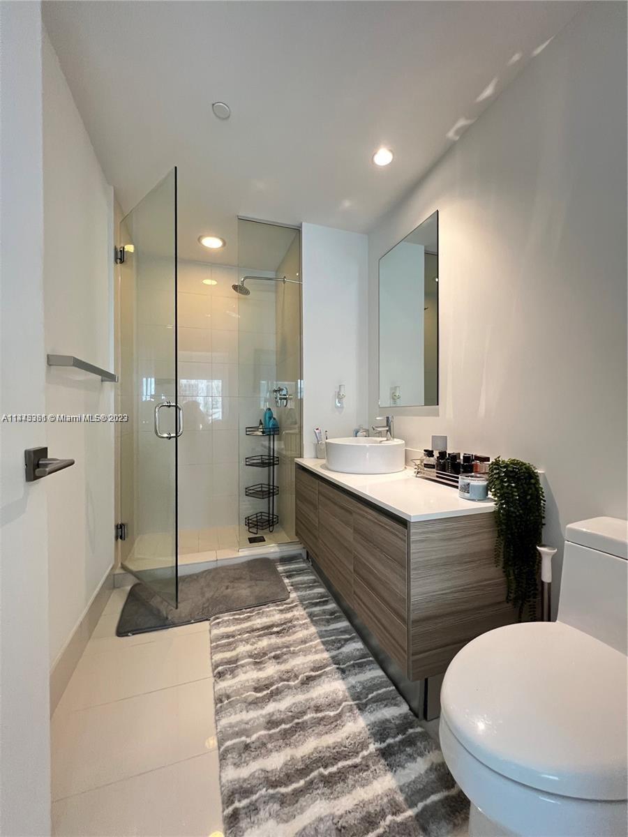 Midtown Miami Miami, FL 33137 - Photo 13 of 14 a bathroom with a double vanity sink toilet and shower