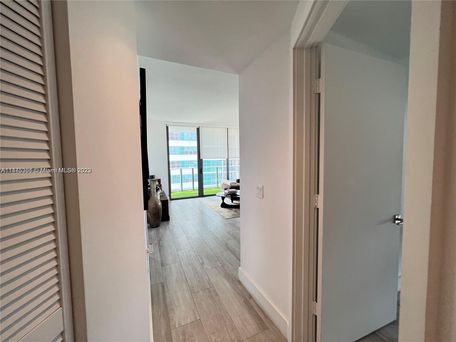 Midtown Miami Miami, FL 33137 - Photo 14 of 14 a view of a hallway with wooden floor fireplace and living room
