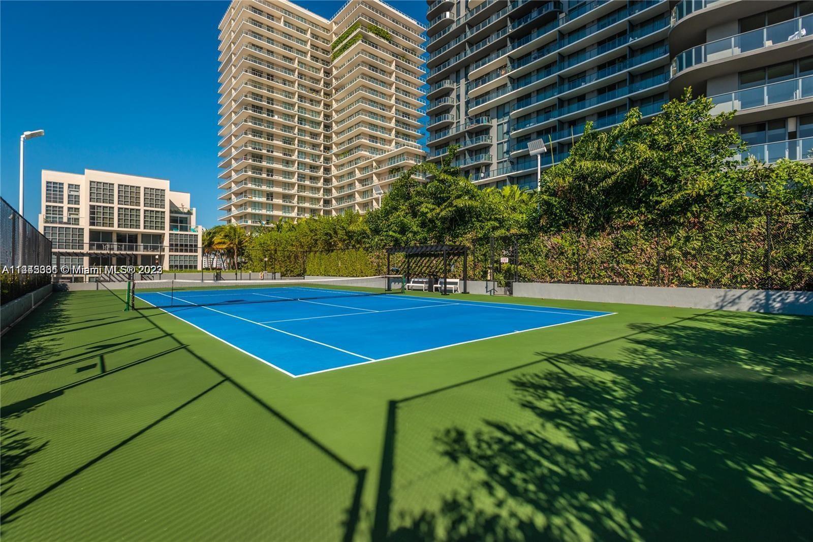 Midtown Miami Miami, FL 33137 - Photo 8 of 14 a view of a tennis ground with large trees