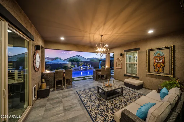 a view of a swimming pool with seating space and furniture