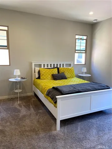 a living room with a bed furniture and a window