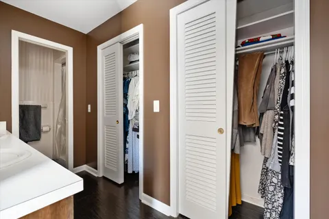 a view of walk in closet with clothes and shoes