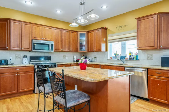 a kitchen with a stove a sink and a refrigerator