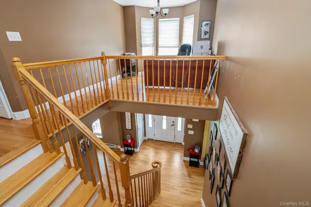 a view of staircase with railing and a large window
