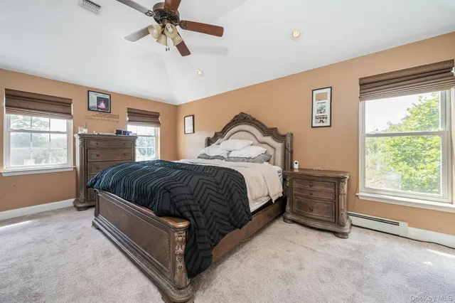 a bedroom with a bed lamp and window