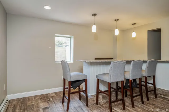 a view of a a dining room with furniture and wooden floor