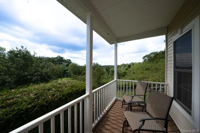 a view of a chair and table in the balcony