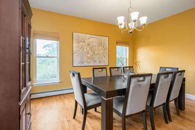 a view of a dining room with furniture and a chandelier