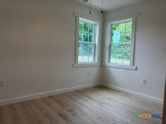 602 South 26th Street Temple, TX 76501 - Photo 8 of 11 an empty room with wooden floor and windows