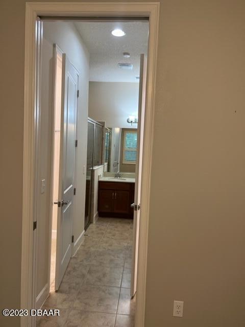 742 Aldenham Lane Ormond Beach, FL 32174 - Photo 17 of 25 a bathroom with a glass door shower a sink and a mirror
