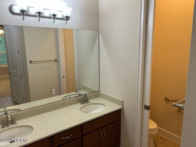 742 Aldenham Lane Ormond Beach, FL 32174 - Photo 19 of 25 a bathroom with a granite countertop sink and a mirror