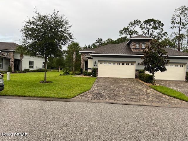 742 Aldenham Lane Ormond Beach, FL 32174 - Photo 20 of 25 a front view of a house with a yard and garage