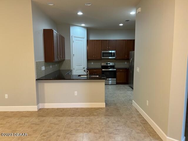 742 Aldenham Lane Ormond Beach, FL 32174 - Photo 5 of 25 a view of kitchen with stainless steel appliances a refrigerator and a stove