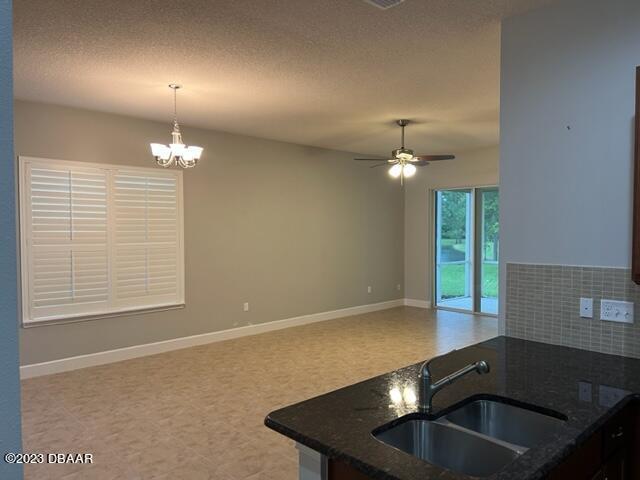 742 Aldenham Lane Ormond Beach, FL 32174 - Photo 7 of 25 a kitchen with a sink and chandelier
