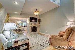 a living room with furniture a flat screen tv and a fireplace