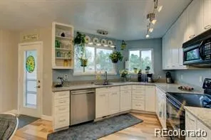 a kitchen with a sink stove and cabinets
