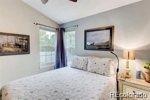 a bedroom with a bed and a painting on the wall