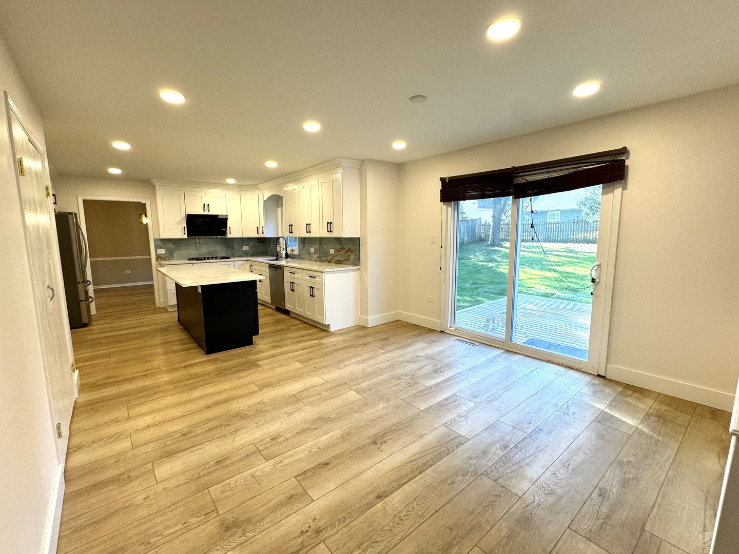 1398 East Gartner Road Naperville, IL 60540 - Photo 10 of 31 a view of kitchen with kitchen island wooden floor center island and stainless steel appliances