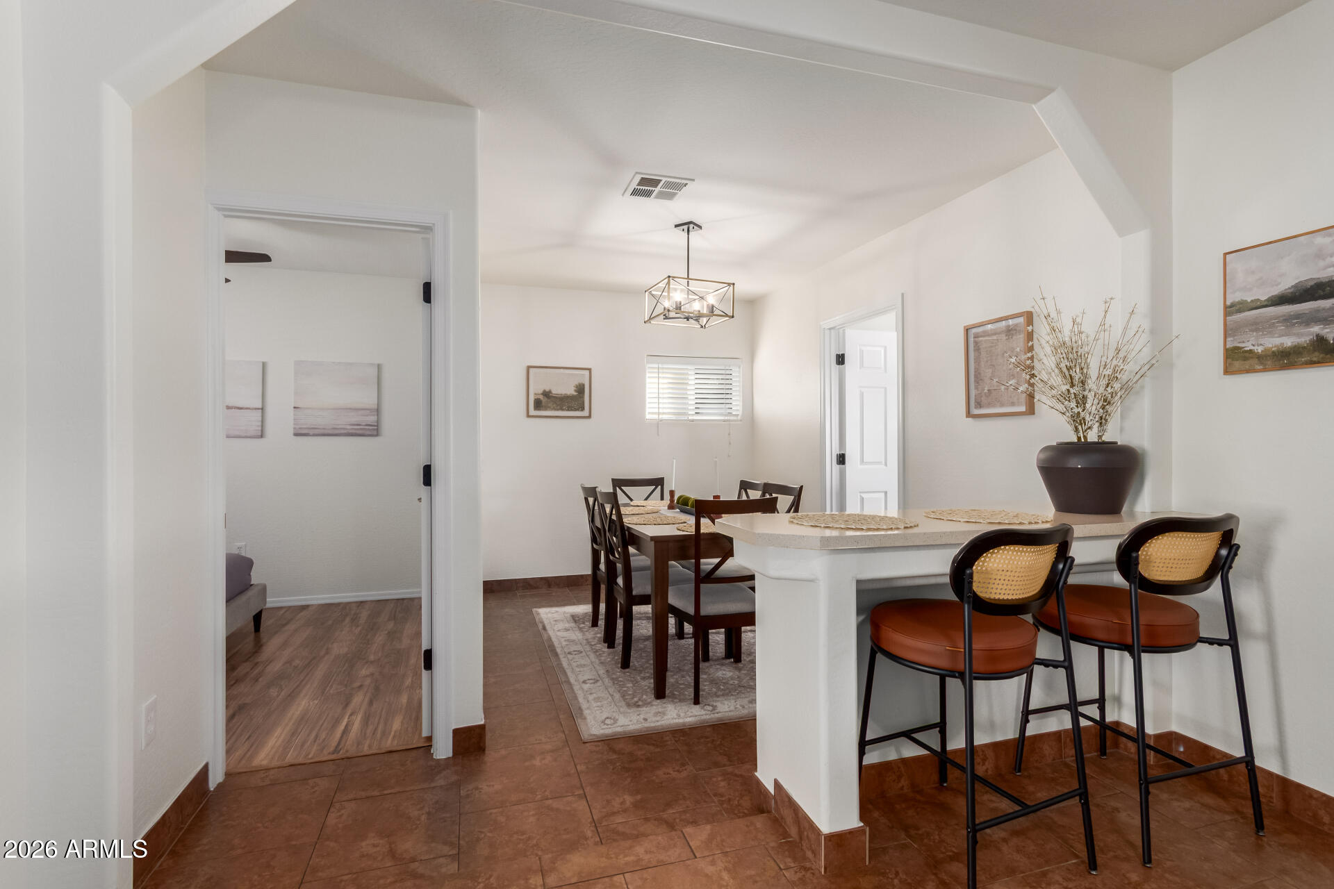 2715 West Royal Palm Road Phoenix, AZ 85051 - Photo 13 of 32 a view of a dining room with furniture and wooden floor