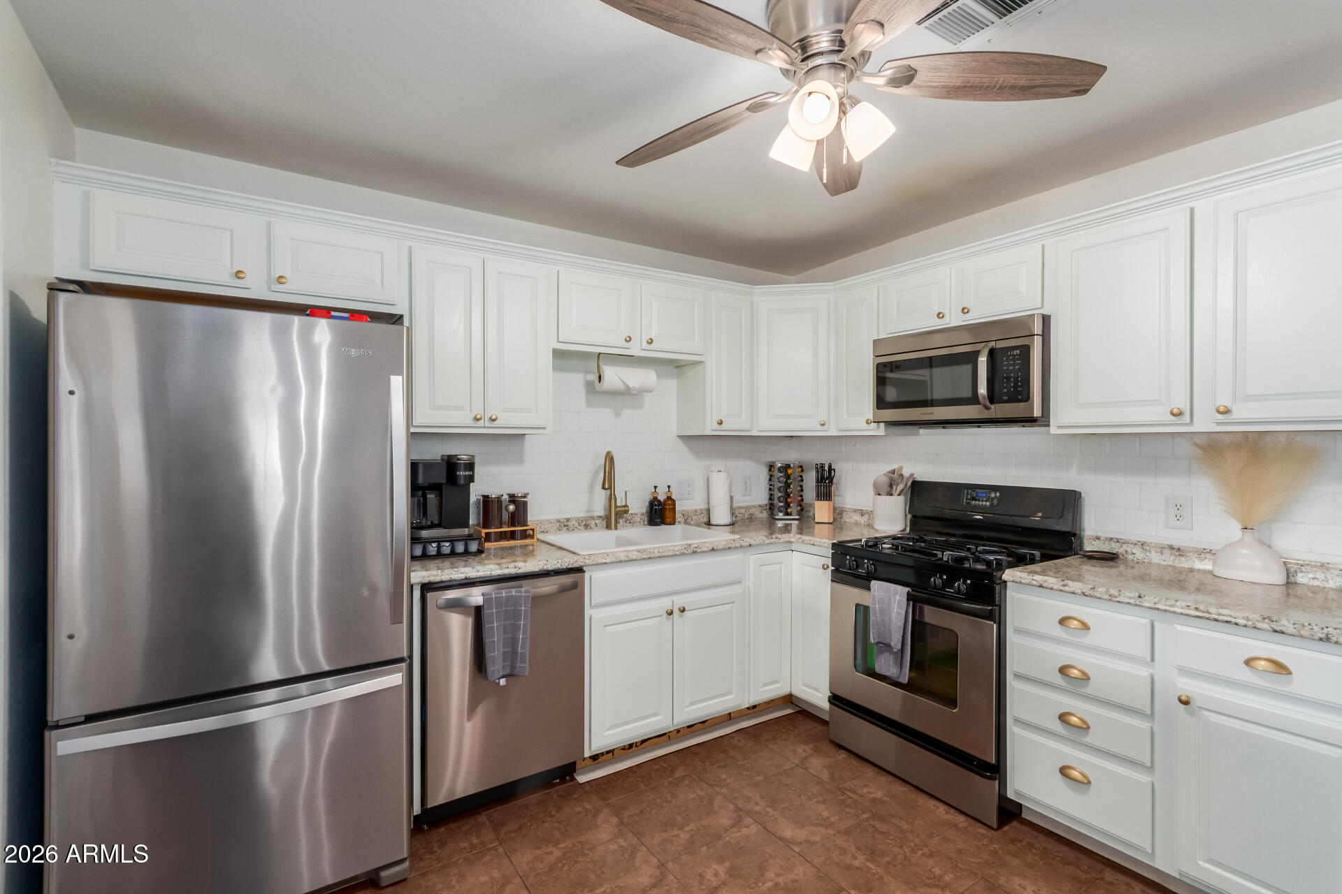 2715 West Royal Palm Road Phoenix, AZ 85051 - Photo 15 of 32 a kitchen with cabinets stainless steel appliances and a counter space