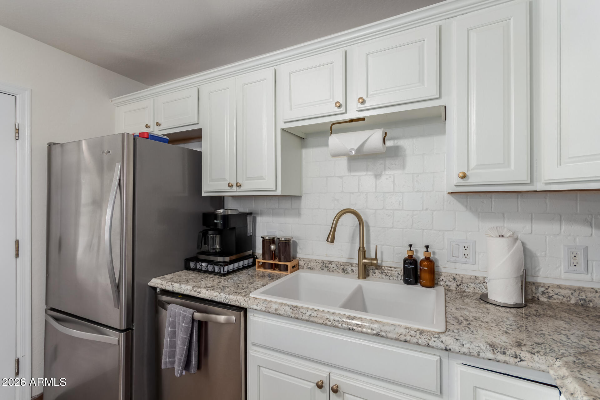 2715 West Royal Palm Road Phoenix, AZ 85051 - Photo 17 of 32 a kitchen with granite countertop a refrigerator sink and cabinets