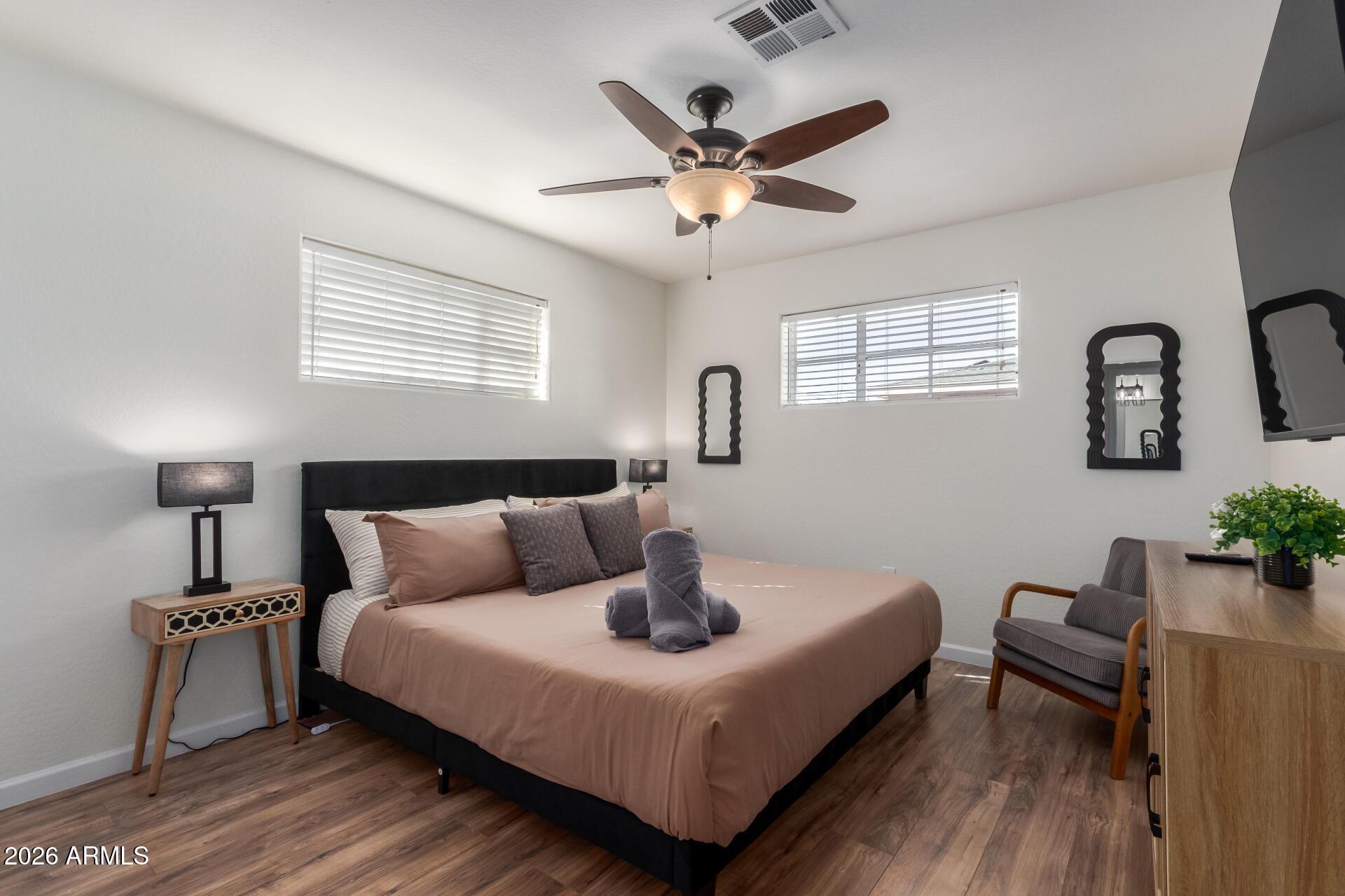 2715 West Royal Palm Road Phoenix, AZ 85051 - Photo 19 of 32 a bedroom with a bed and wooden floor