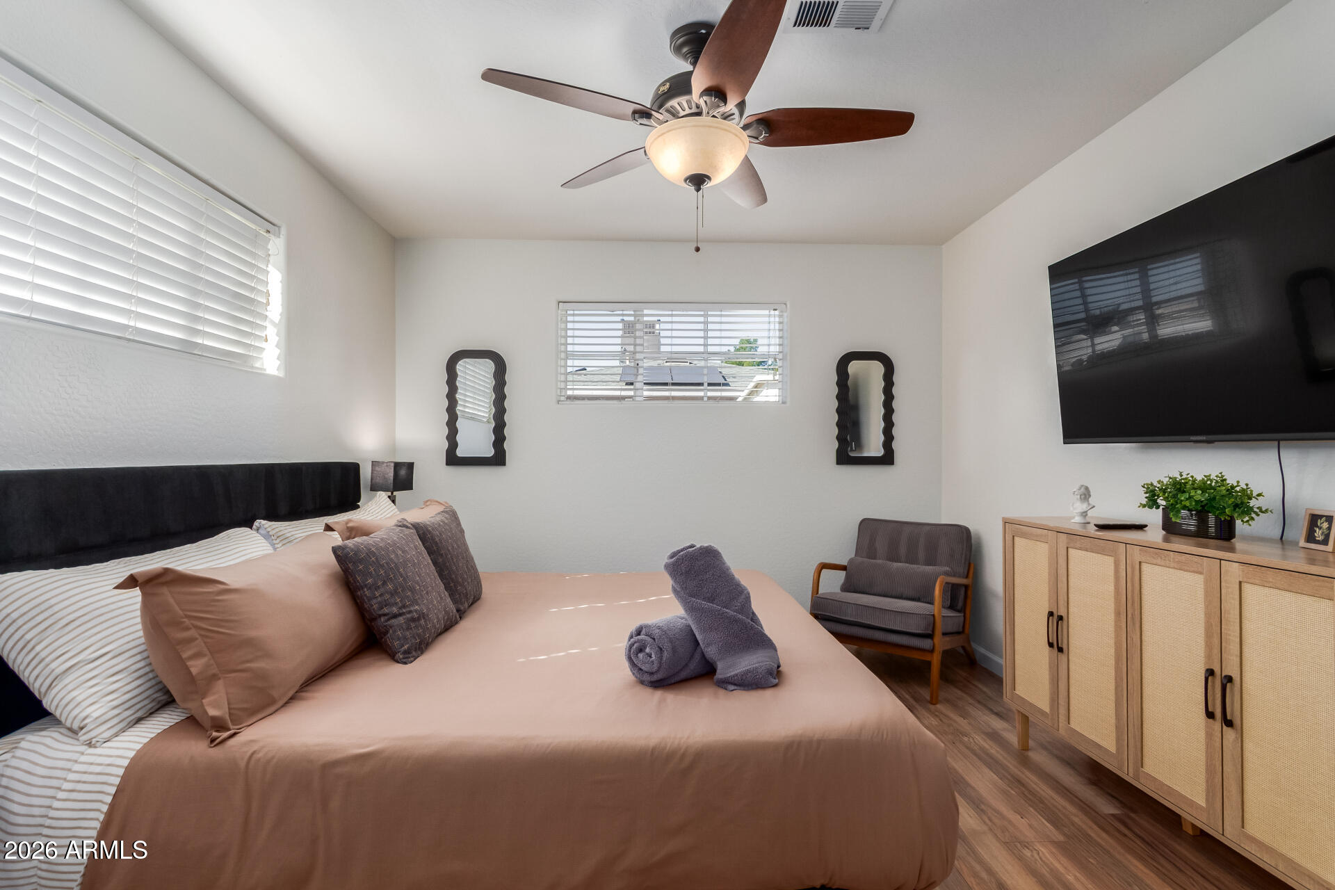 2715 West Royal Palm Road Phoenix, AZ 85051 - Photo 20 of 32 a bedroom with furniture a flat screen tv and a window