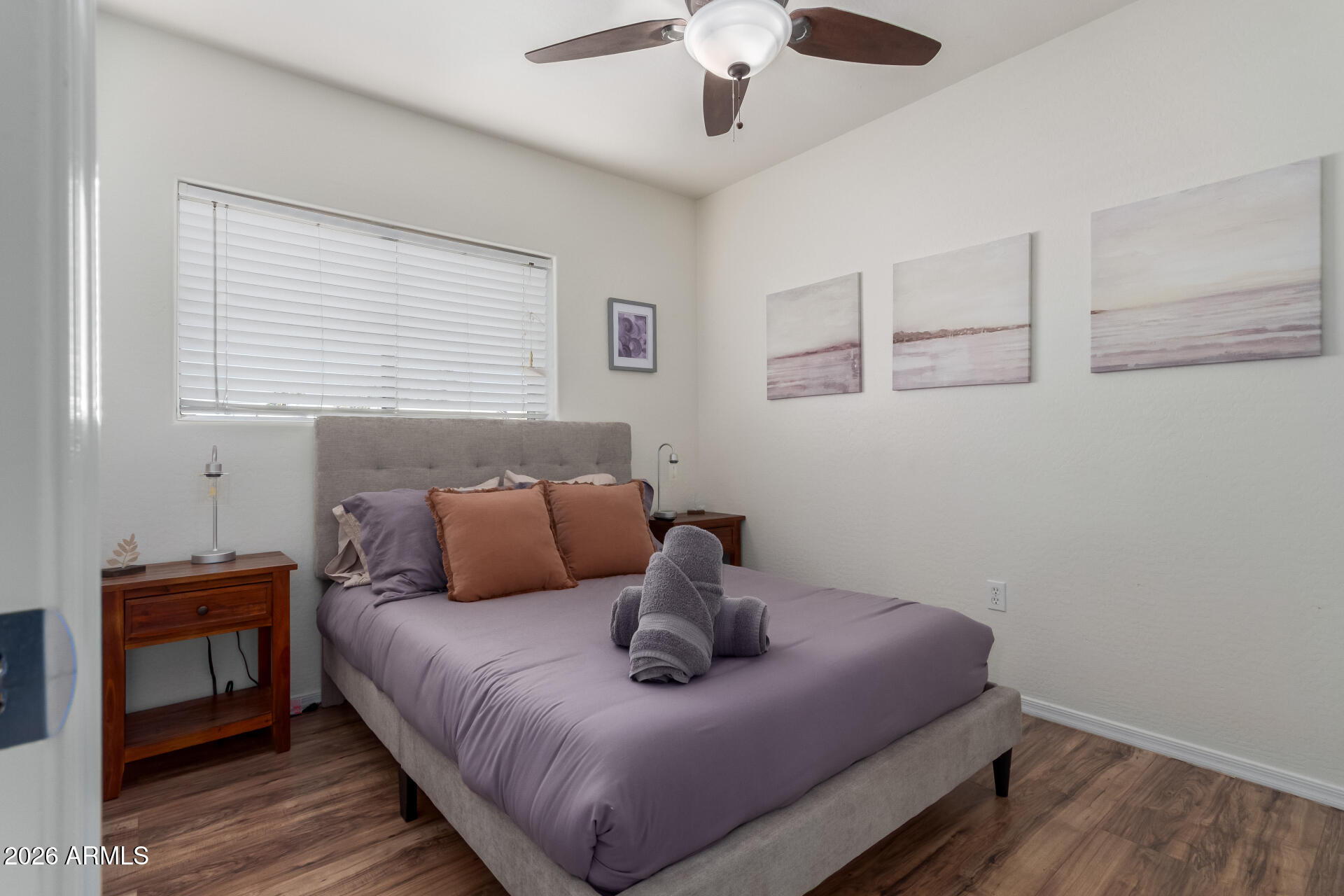 2715 West Royal Palm Road Phoenix, AZ 85051 - Photo 21 of 32 a bedroom with a bed and wooden floor