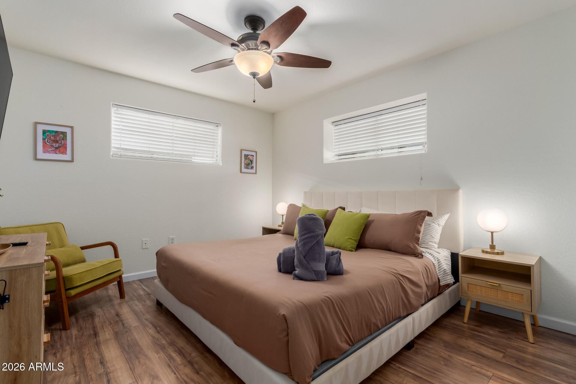 2715 West Royal Palm Road Phoenix, AZ 85051 - Photo 23 of 32 a bedroom with a bed and wooden floor