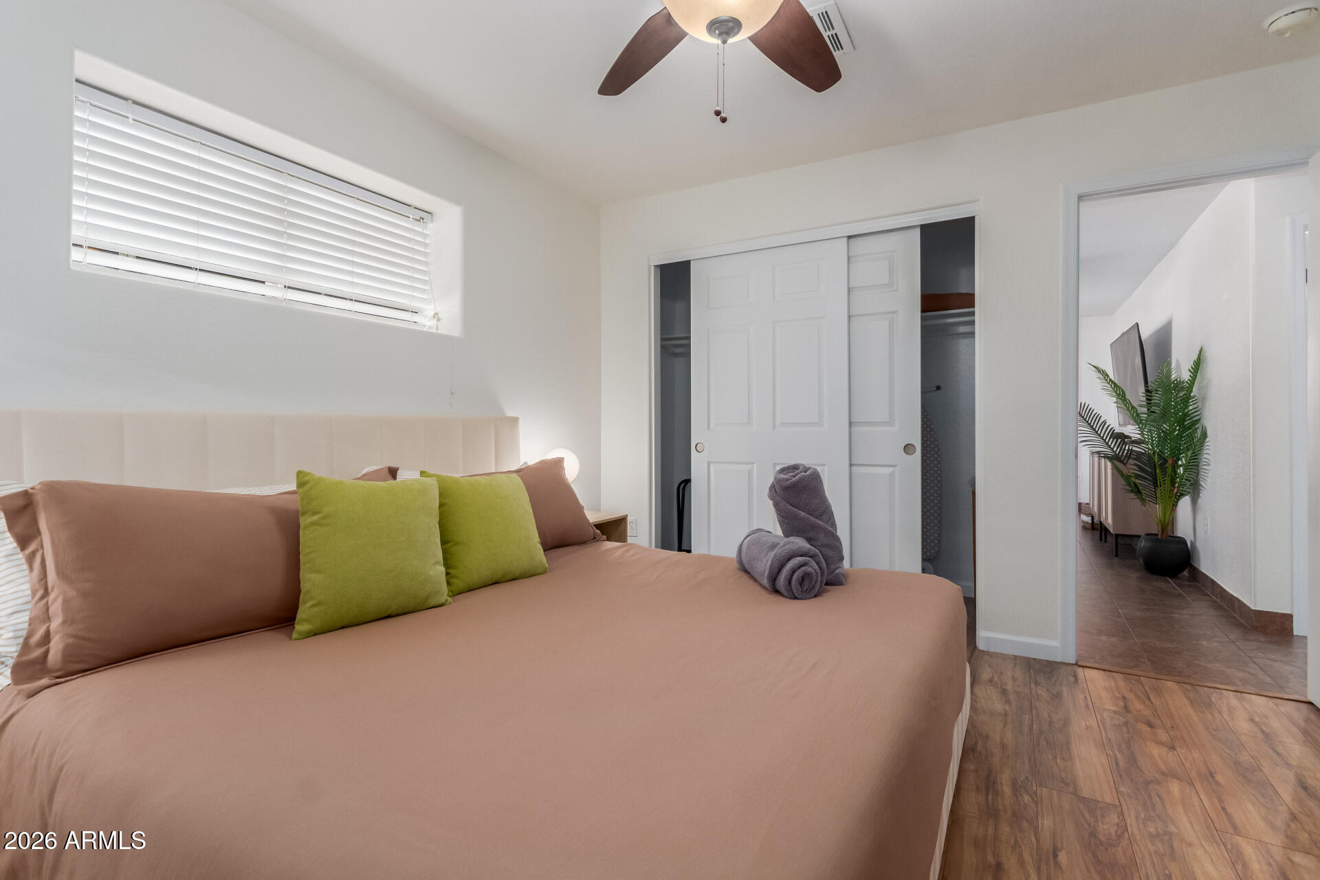 2715 West Royal Palm Road Phoenix, AZ 85051 - Photo 24 of 32 a bedroom with a bed and ceiling fan