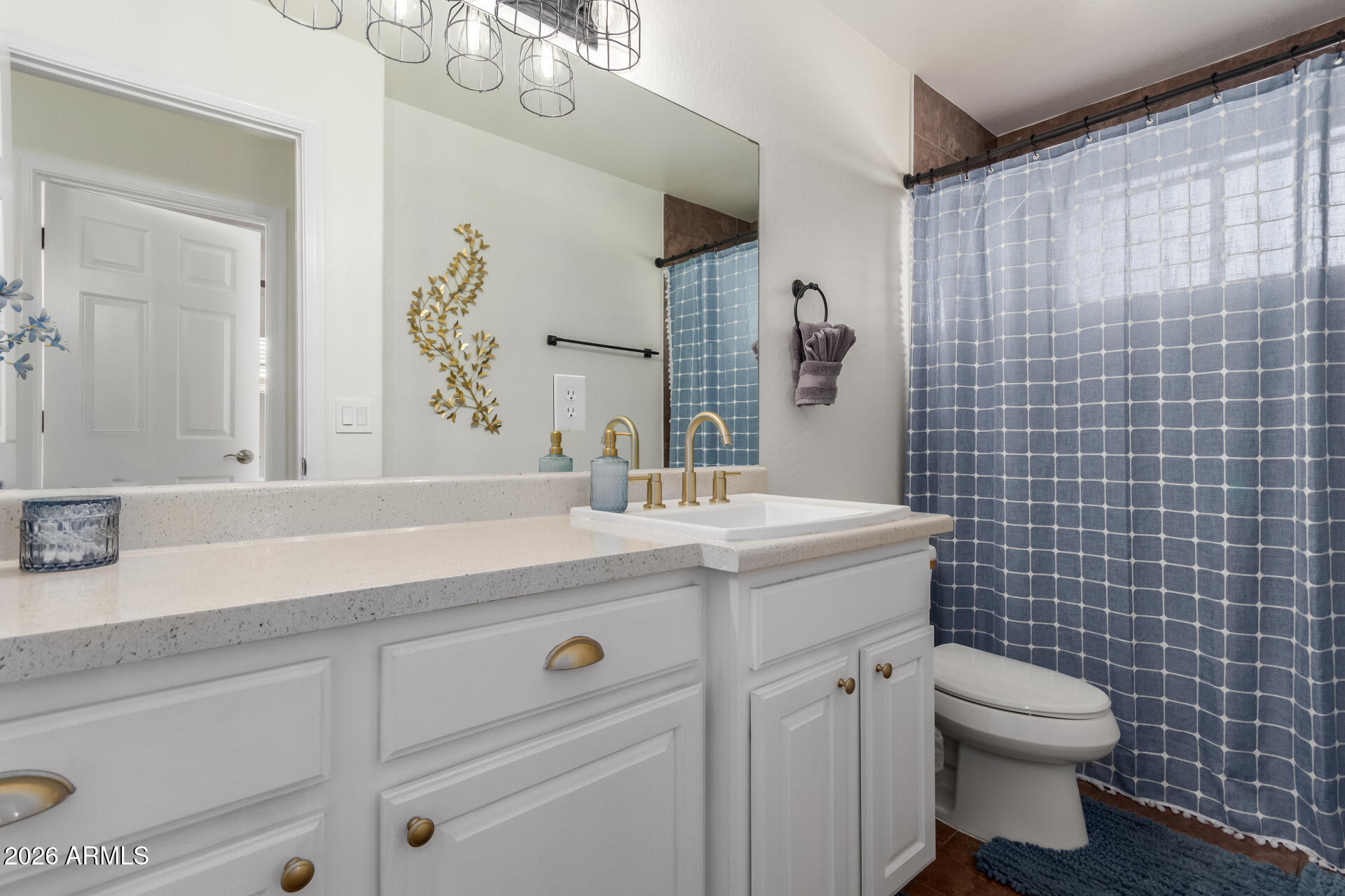 2715 West Royal Palm Road Phoenix, AZ 85051 - Photo 25 of 32 a bathroom with a granite countertop sink a toilet and a mirror