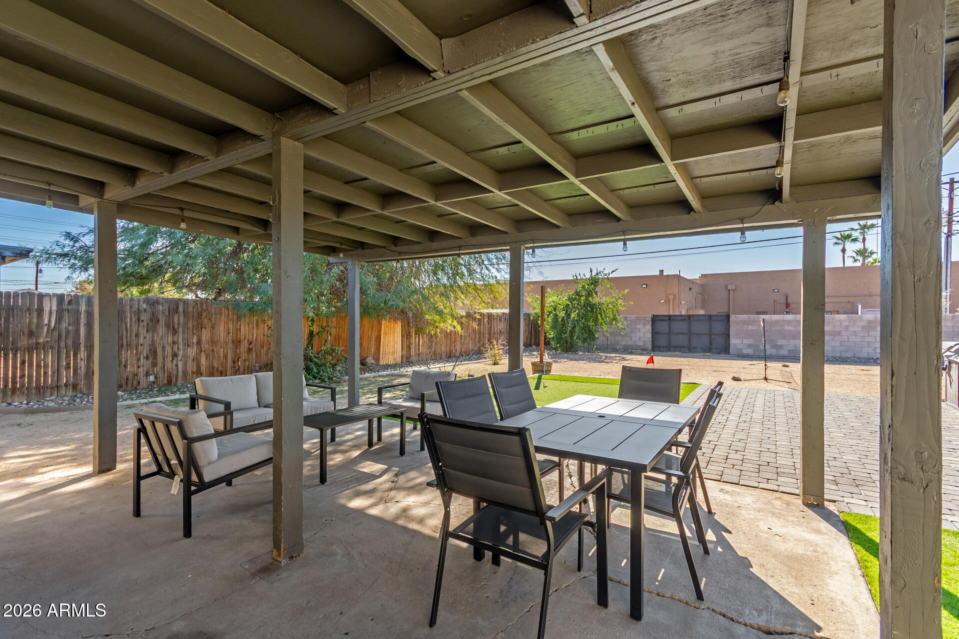 2715 West Royal Palm Road Phoenix, AZ 85051 - Photo 28 of 32 a view of a patio with table and chairs and floor to ceiling window with wooden floor