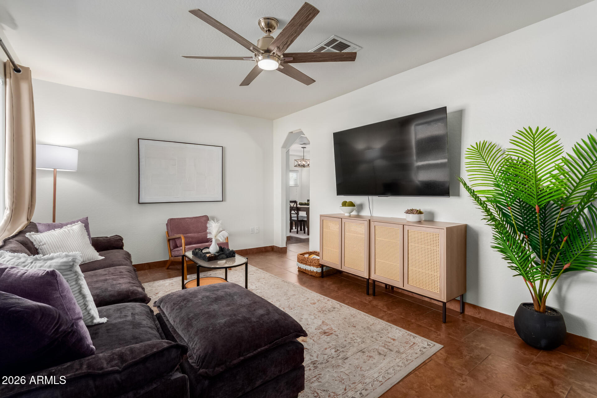2715 West Royal Palm Road Phoenix, AZ 85051 - Photo 7 of 32 a living room with furniture and a flat screen tv