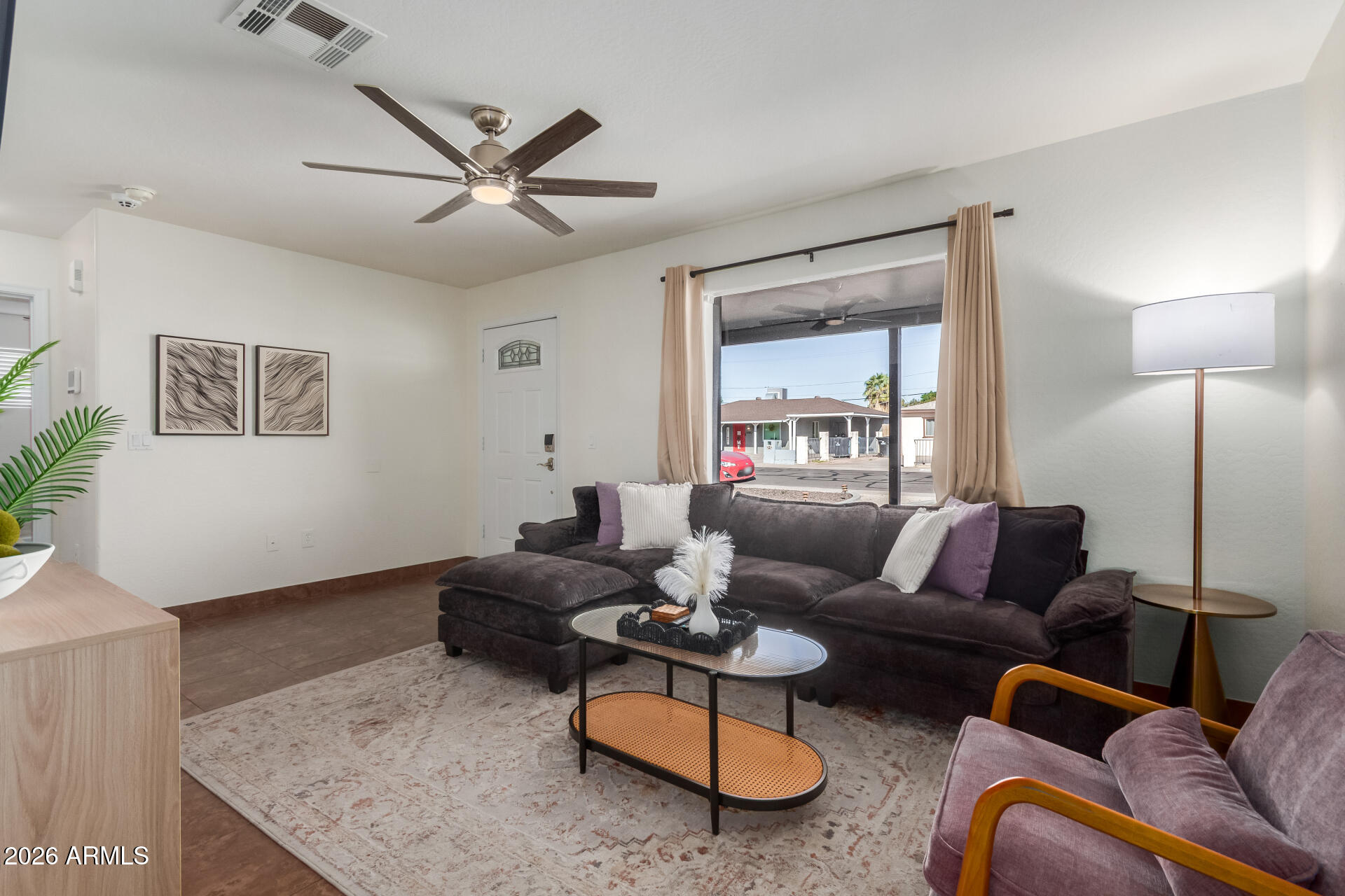 2715 West Royal Palm Road Phoenix, AZ 85051 - Photo 9 of 32 a living room with furniture and a large window