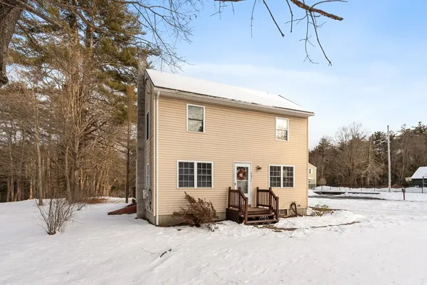 a view of a house with snow on the road