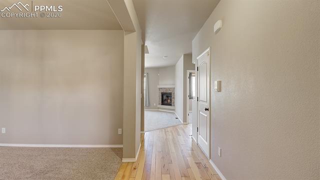 2316 Rusty Ridge Court Colorado Springs, CO 80921 - Photo 7 of 46 Entering the home you can see the beautiful Hickory Hardwood floors and Formal Dining room on the left.