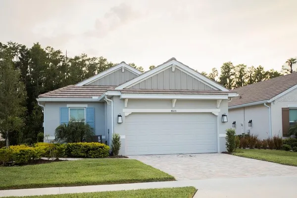 a front view of a house with a garden