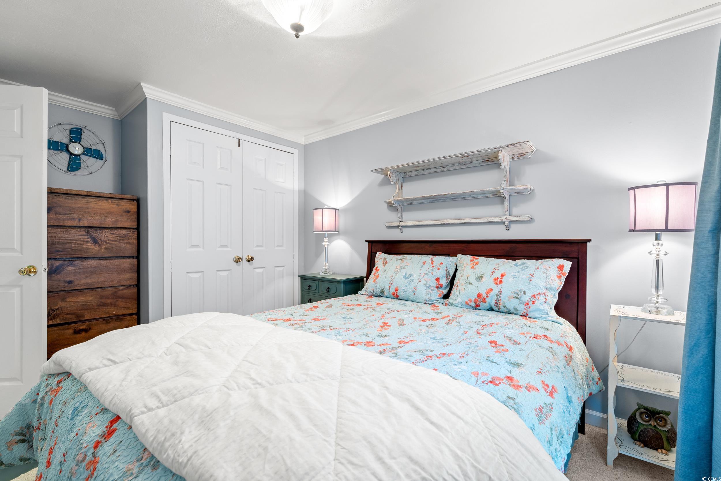 467 Freedom Circle Myrtle Beach, SC 29588 - Photo 12 of 38 Bedroom featuring carpet floors, a closet, and crown molding