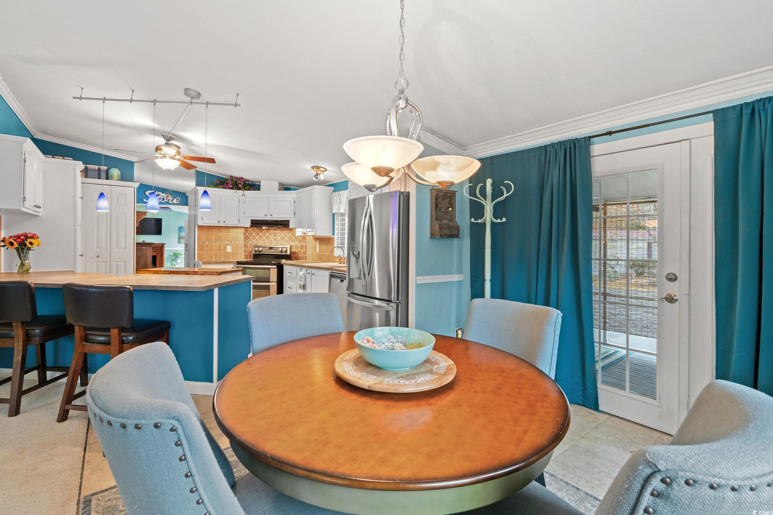 467 Freedom Circle Myrtle Beach, SC 29588 - Photo 15 of 38 Dining room featuring crown molding, healthy amount of natural light, and a ceiling fan