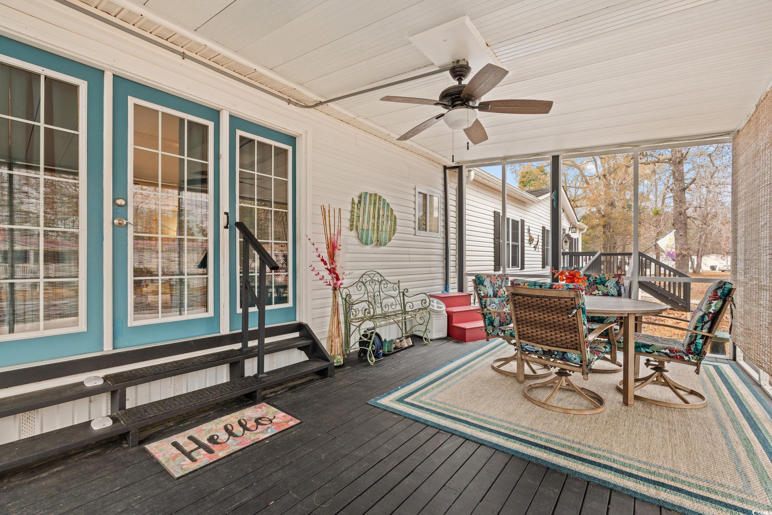 467 Freedom Circle Myrtle Beach, SC 29588 - Photo 26 of 38 Sunroom / solarium with outdoor dining area, ceiling fan, and a wooden deck