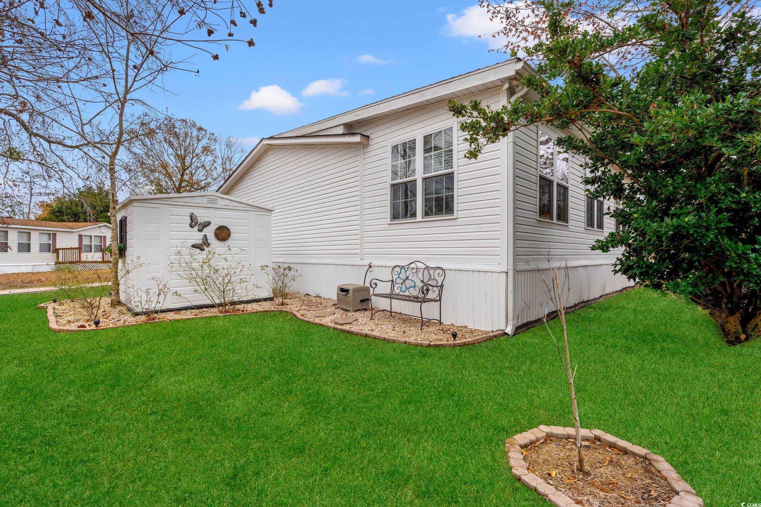 467 Freedom Circle Myrtle Beach, SC 29588 - Photo 29 of 38 View of property exterior with a lawn and an outdoor structure