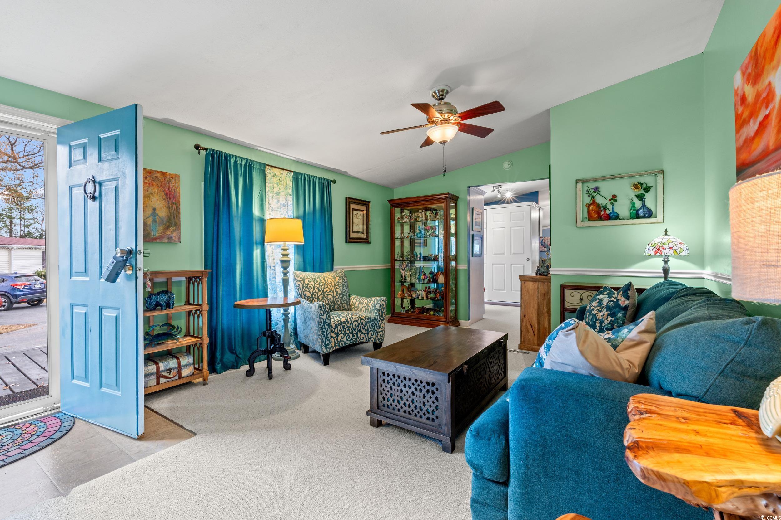 467 Freedom Circle Myrtle Beach, SC 29588 - Photo 6 of 38 Living area featuring vaulted ceiling, carpet flooring, ceiling fan, and plenty of natural light