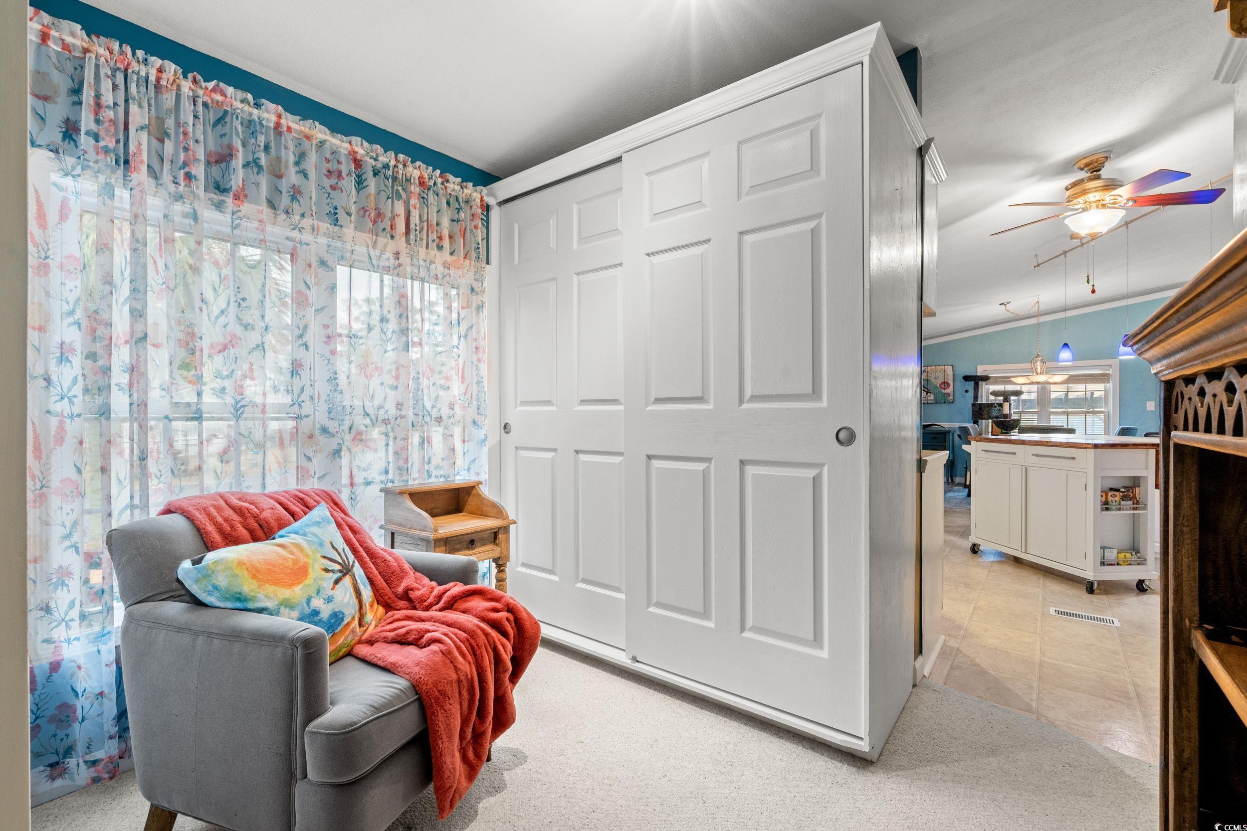 467 Freedom Circle Myrtle Beach, SC 29588 - Photo 8 of 38 Living area with a ceiling fan, light colored carpet, and vaulted ceiling