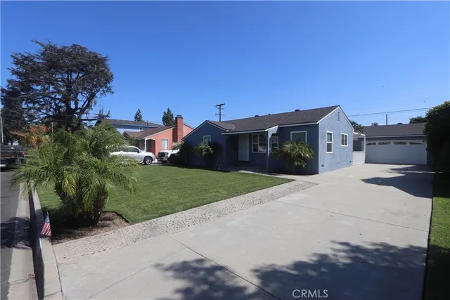 a front view of a house with a yard and a garage