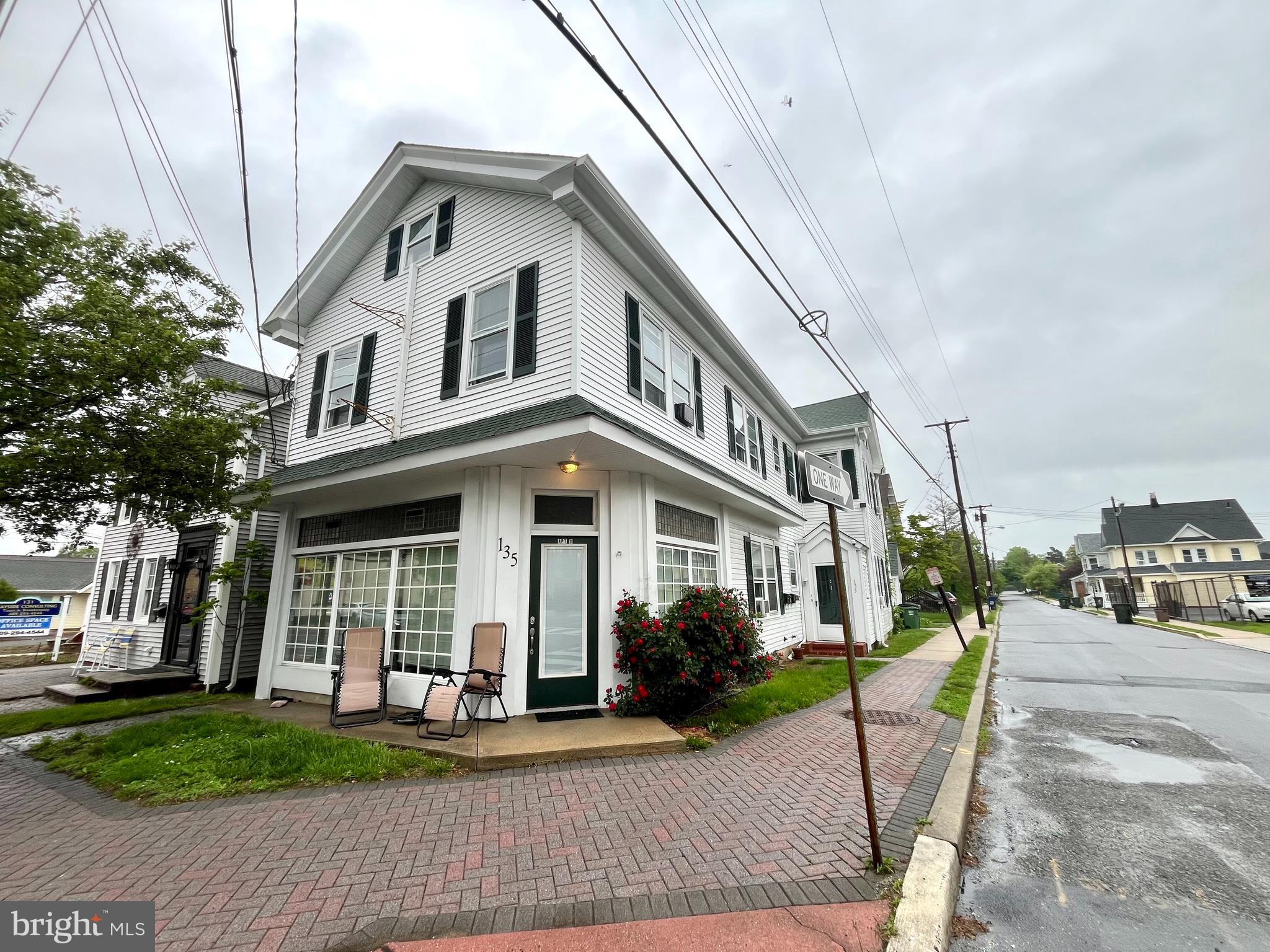 135 East Main Street Tuckerton, NJ 08087 - Photo 2 of 6 a view of a white house with large windows next to a road