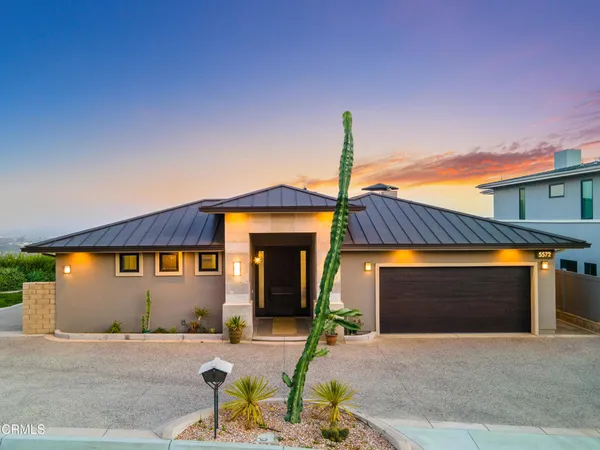 a front view of a house with parking area