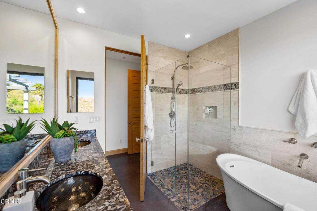 5572 Rainier Street Ventura, CA 93003 - Photo 11 of 29 a bathroom with a tub shower and a mirror