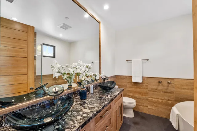 a room with a couch and potted plant on the table