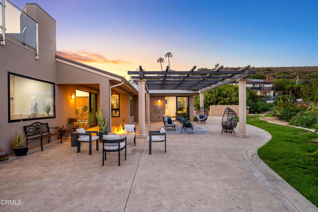 5572 Rainier Street Ventura, CA 93003 - Photo 18 of 29 a view of a patio with dining table and chairs with a barbeque grill and plants