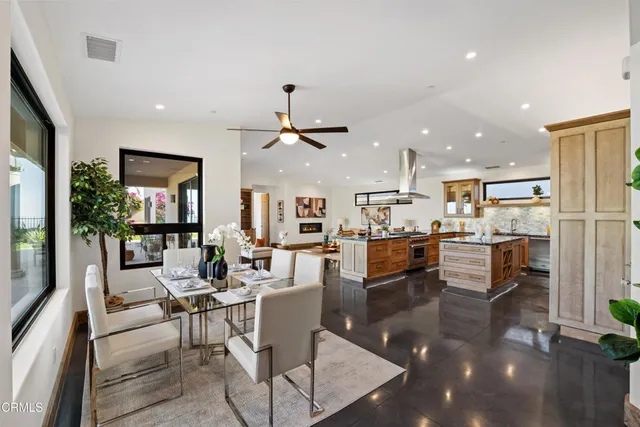 a living room with lots of furniture and kitchen view